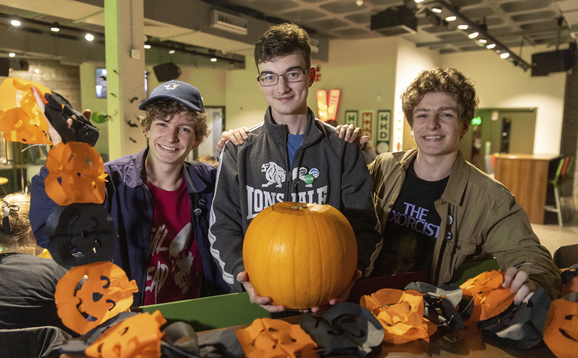 Students carving pumpkins for Halloween