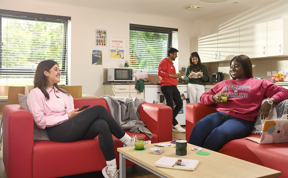 Students in living room and kitchen of their student accommodation