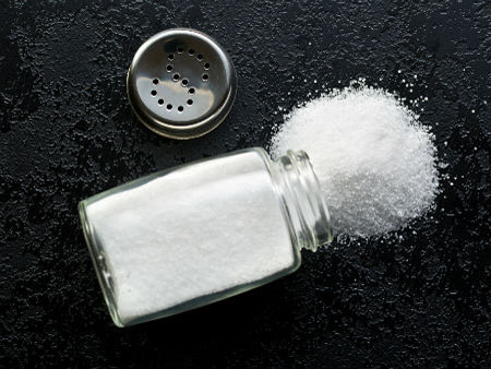 Salt on table, spilling from overturned salt cellar