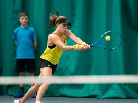 Tennis player Maia Lumsden hitting backhand shot