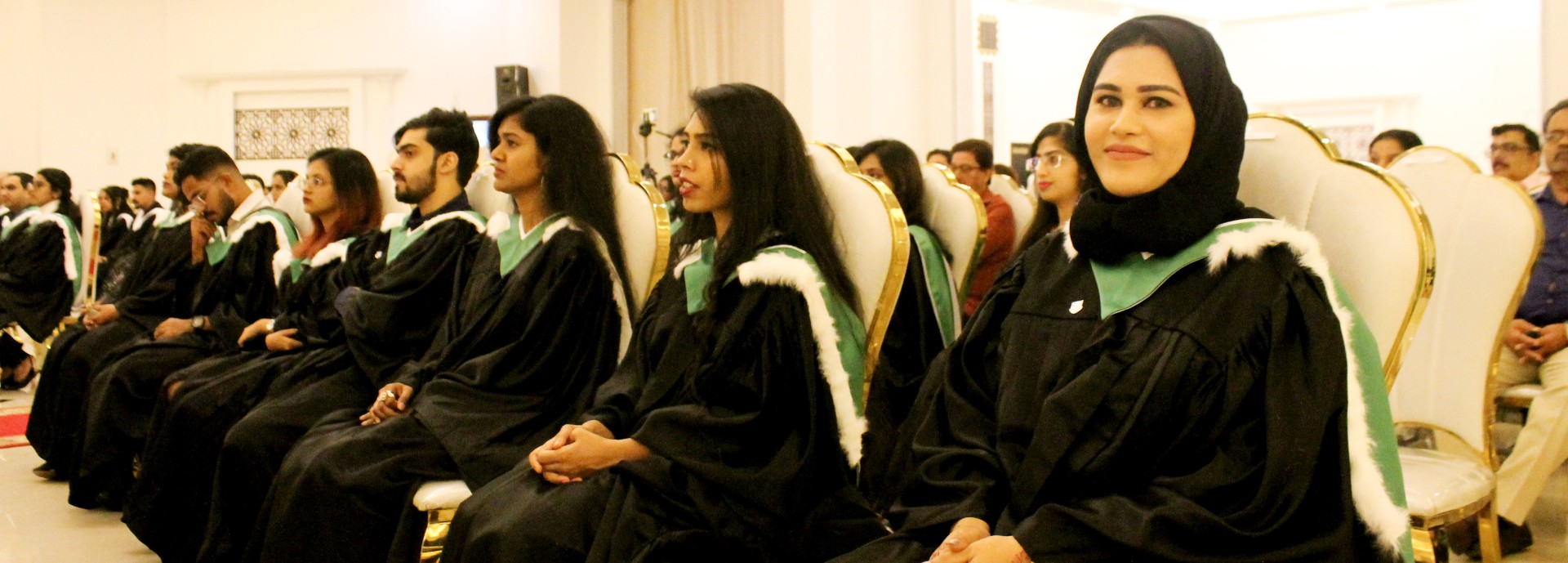 Graduates sitting during the graduation celebration event at Stirling's RAK campus