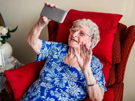 Woman using smartphone in a care home