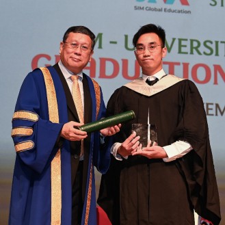 A Singapore graduate receiving an award during the ceremony