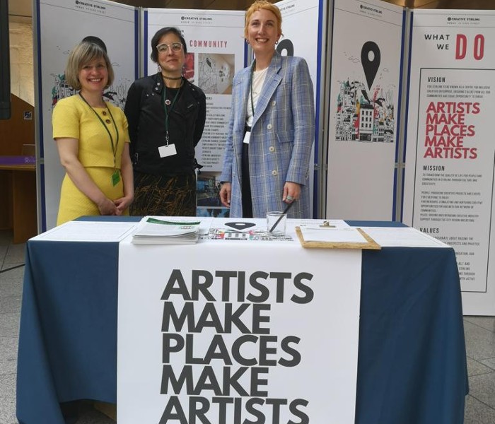 Katherine Champion and colleagues manning a stall at a Scottish Parliament event promoting Creative Stirling