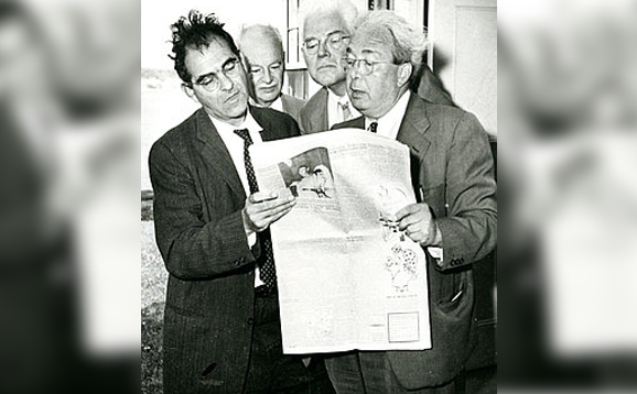 men looking at newspaper