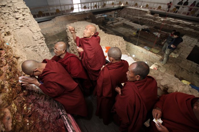 Pilgrims meditate at the wall below the nativity scene within the Maya Devi Temple.