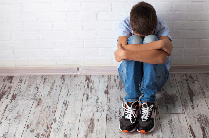 Adolescent sitting down 