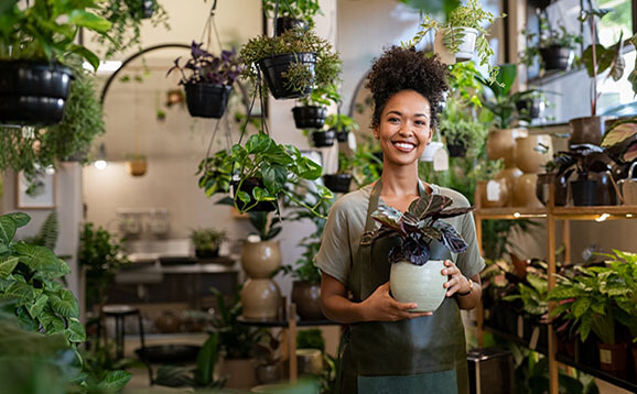 Small business owner smiling in her plant shop