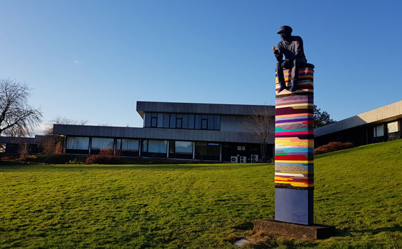 The blue boy sculpture in front of the Pathfoot building
