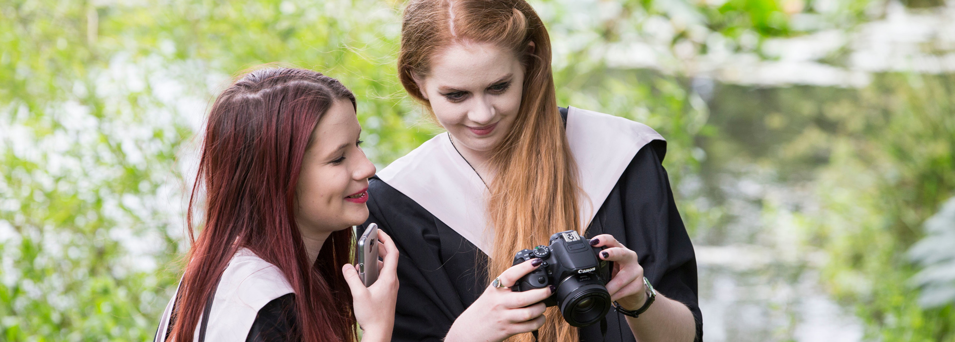 women with camera at graduation