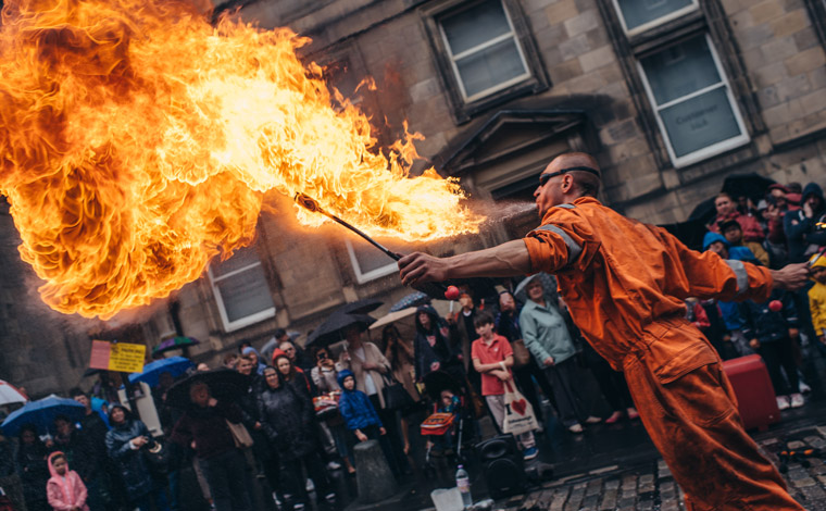 A fire eater street performer at Edinburgh Festival Fringe