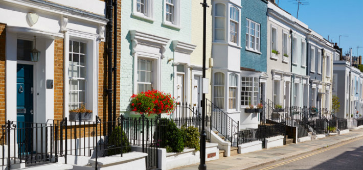 a row of terraced houses that are various colours