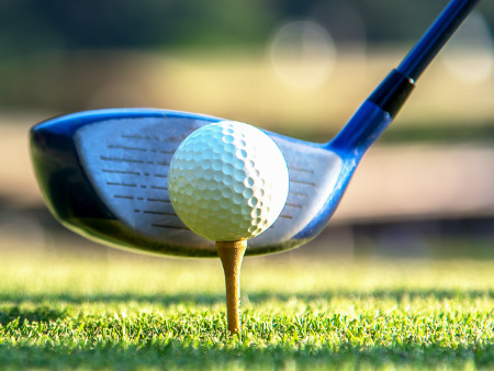 An image of a golf tee and club