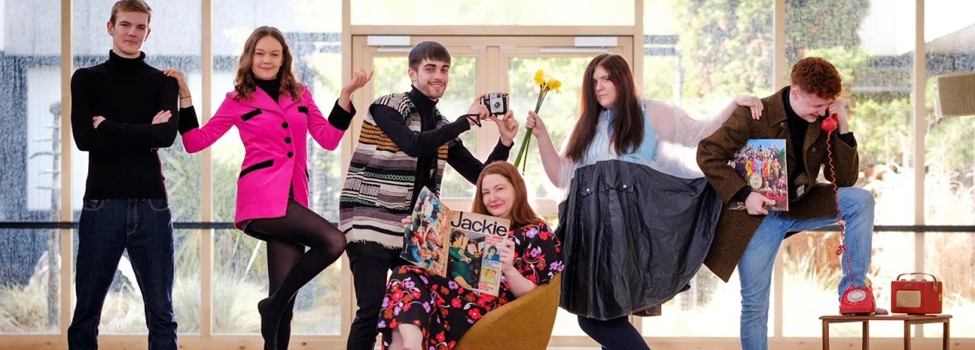 Students pose with items from the 1960s