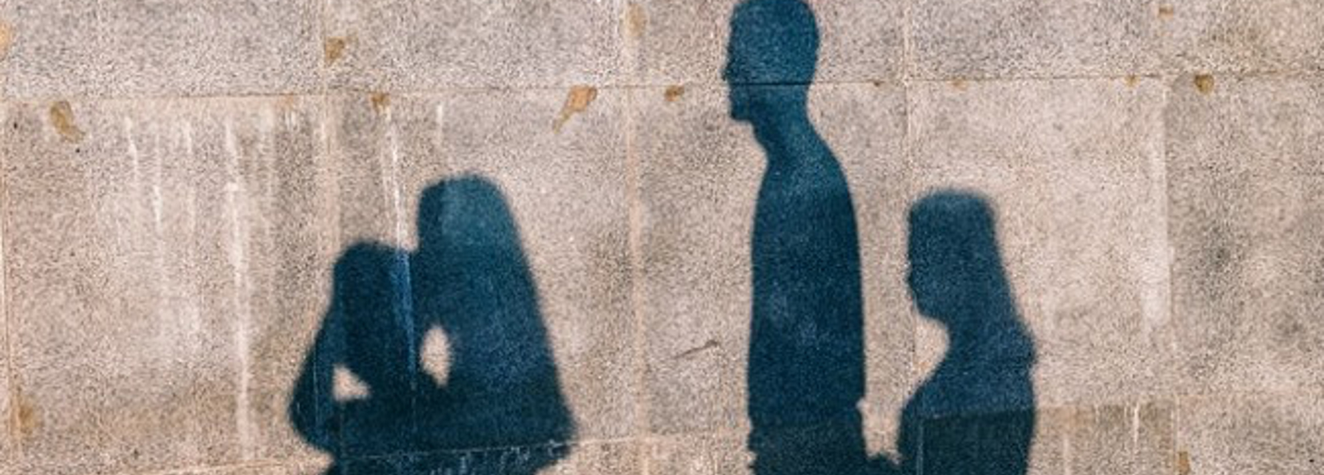 A silhouette of a family on a wall