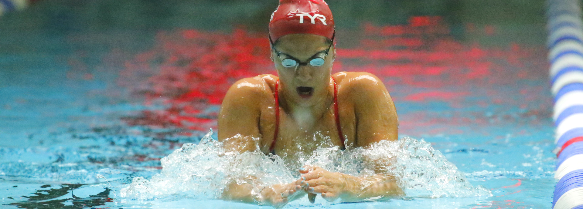 Aimee Willmott swimming breaststroke in University swimming pool