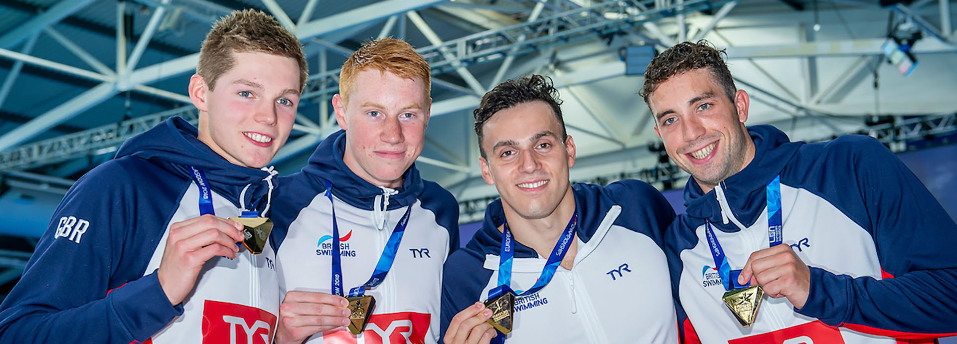 Duncan Scott with relay teammates with medals