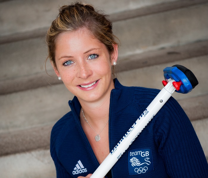 Head shot of Eve Muirhead with curling brush