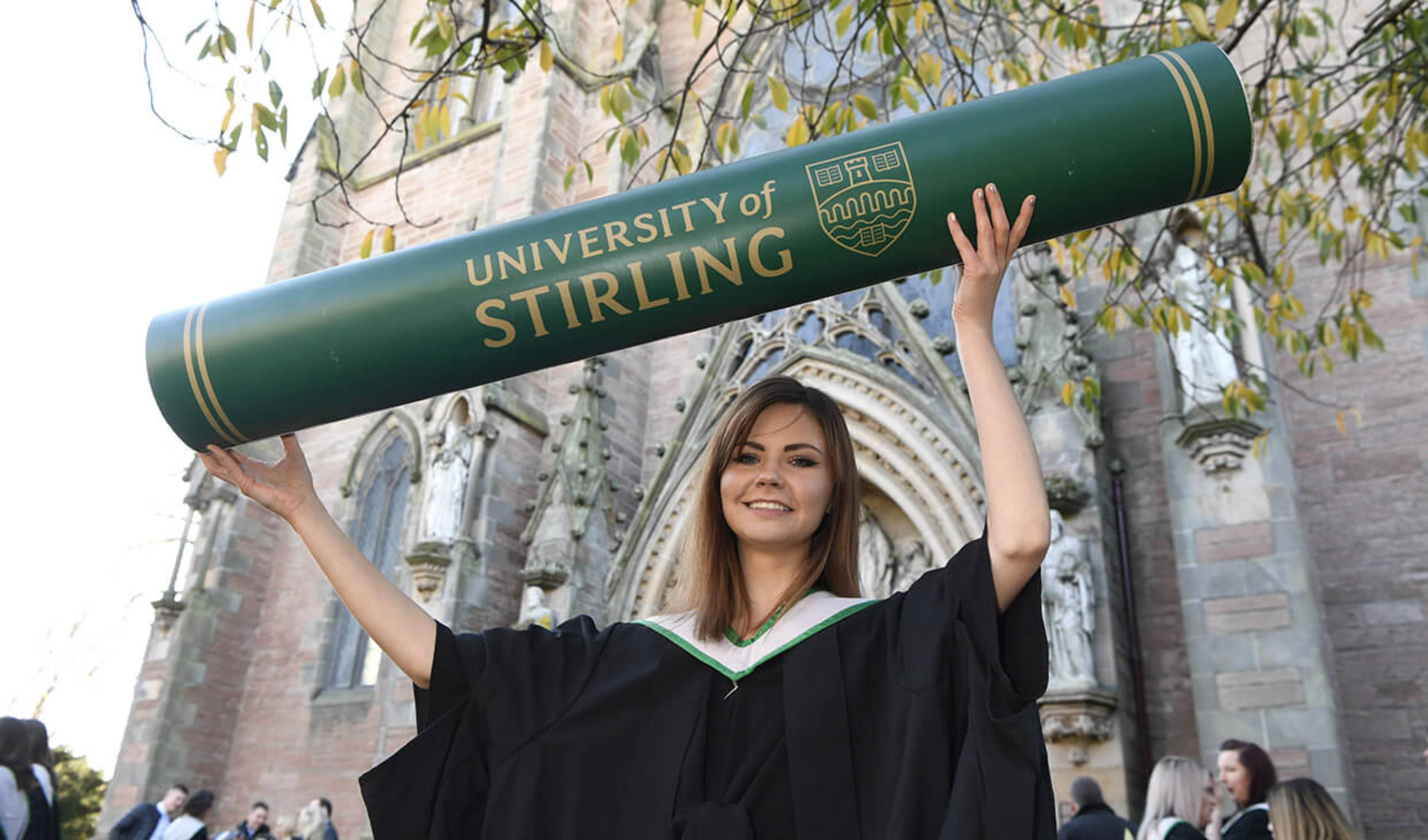 Image of Amie MacDiarmid with graduation scroll
