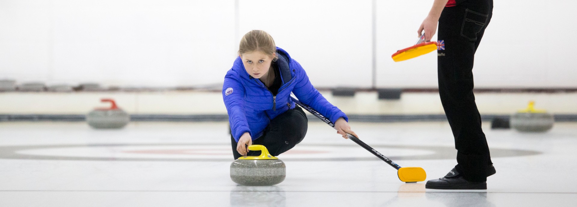 Sophie Jackson throwing curling stone banner