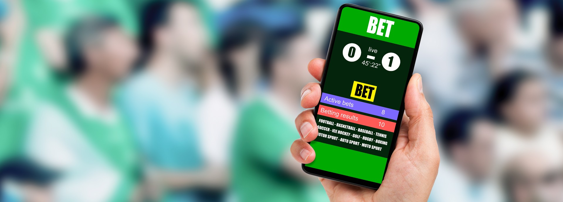 Close-up on man holding a cell phone while winning an online bet on a football game at stadium