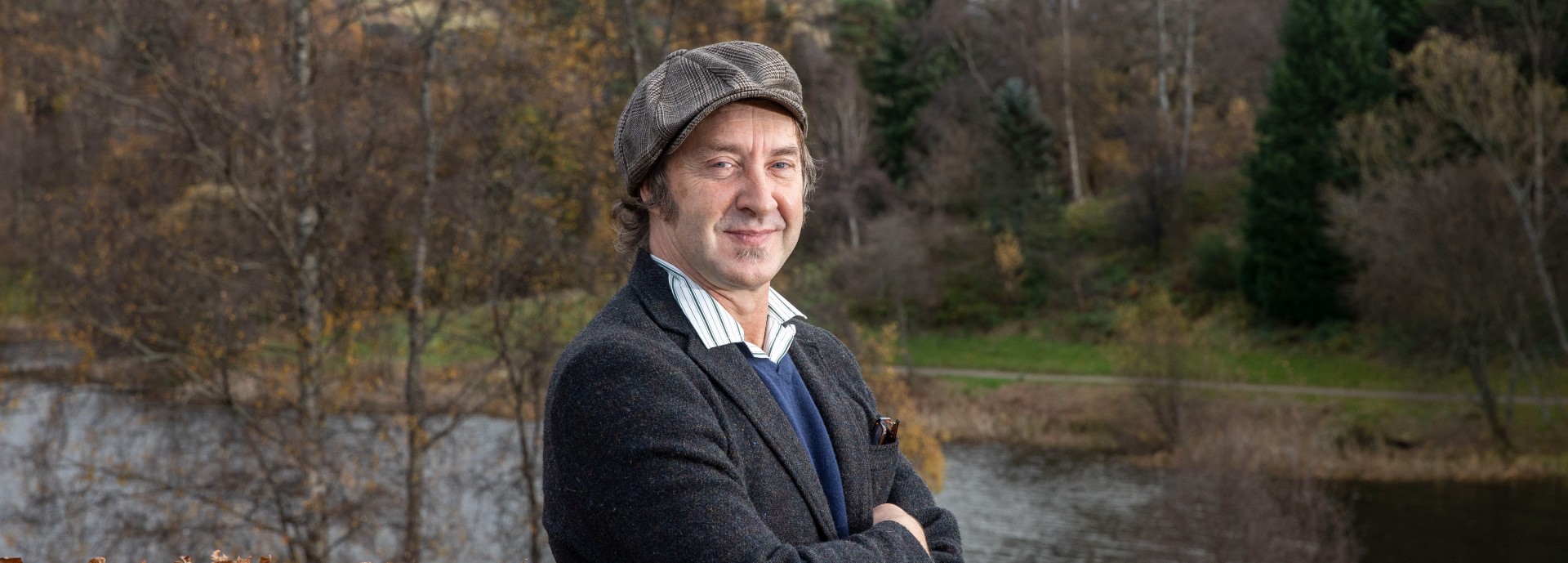 Profile picture of Prof Simon MacKenzie by the Stirling campus loch