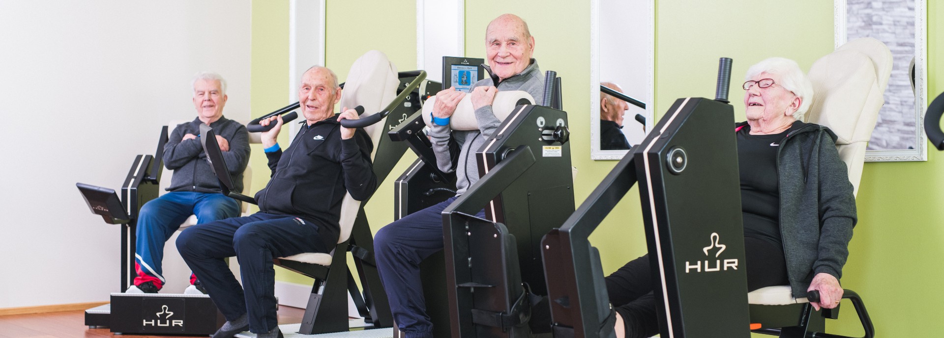 Older people using resistance training equipment