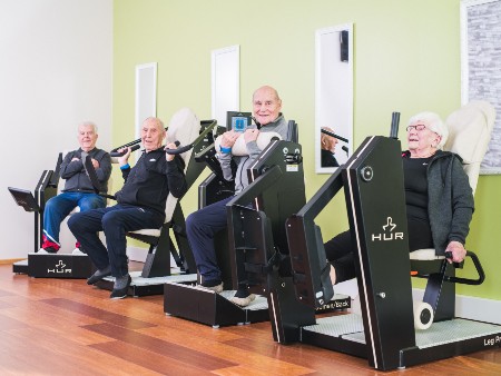 Older people using resistance training equipment