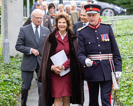 Swedish Royal Family and man in uniform walking towards camera