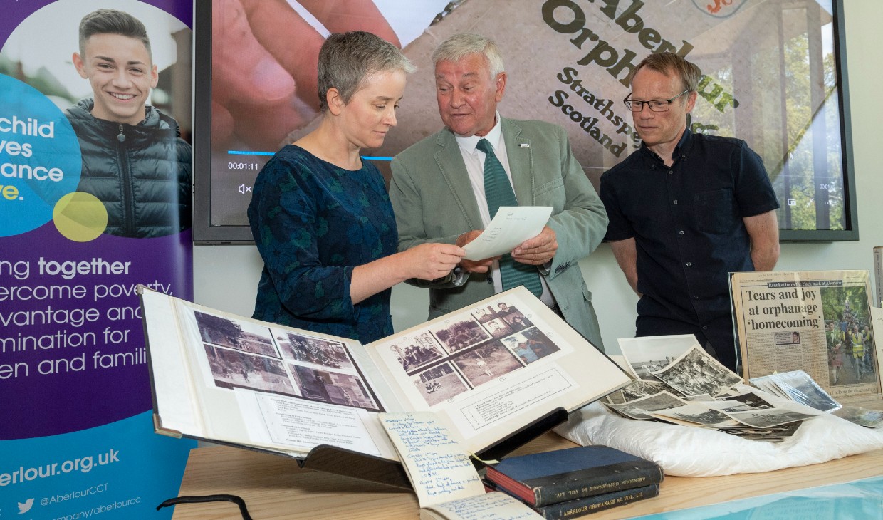 Dean of the Faculty of Arts and Humanities, Kirstie Blair with Ron Aitchison and Karl Magee looking at some of the archive materials