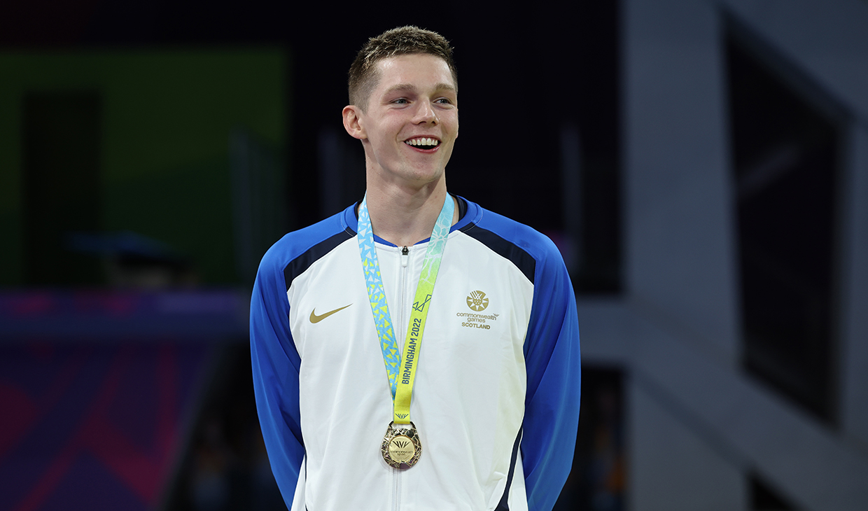 Duncan Scott on podium with gold medal