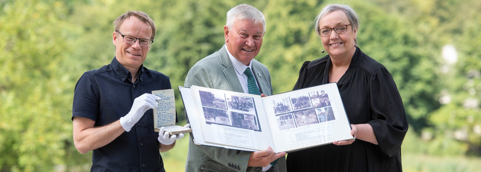 Karl Magee, Ron Aitchison and SallyAnn Kelly pose with items from the new archive