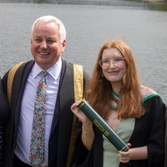 Chancellor poses with family by loch after graduation