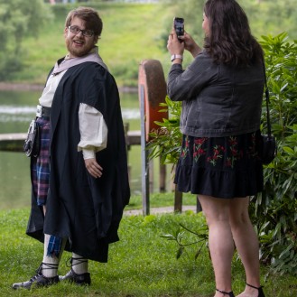 Graduate poses for picture at the gown