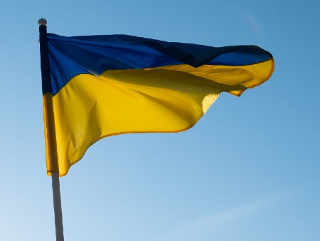 Ukraine flag flying against backdrop of blue sky