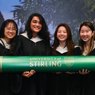 Happy Singapore graduates holding a prop degree from University of Stirling