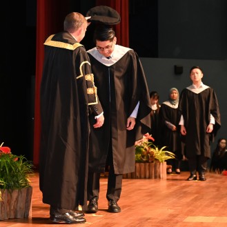 A graduate being capped during the Singapore graduation ceremony