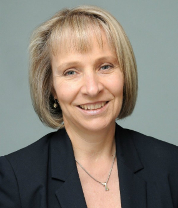 Photograph of Dr Susan Michaelis. She has short bobbed hair and wears a black blazer