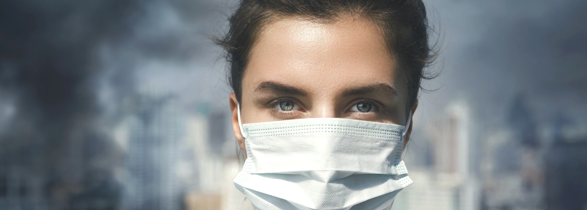 Woman wearing face mask amid air pollution