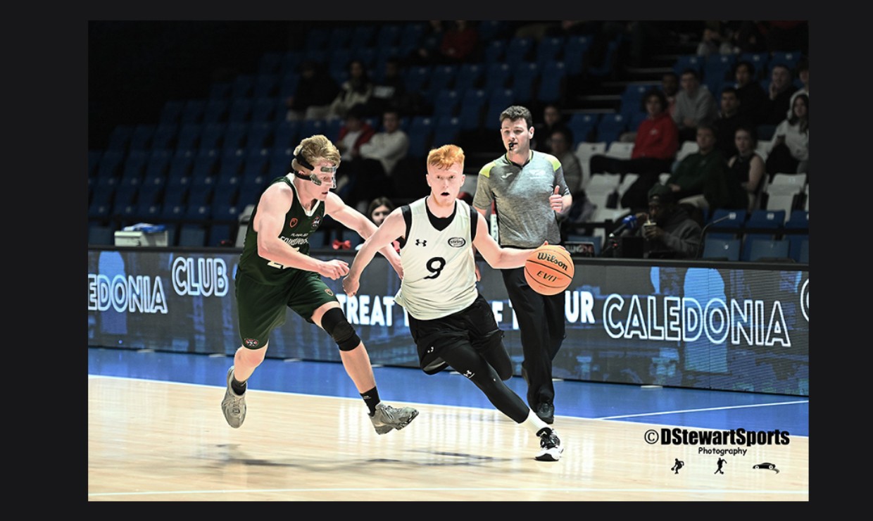 A University of Stirling basketball player in action on the court