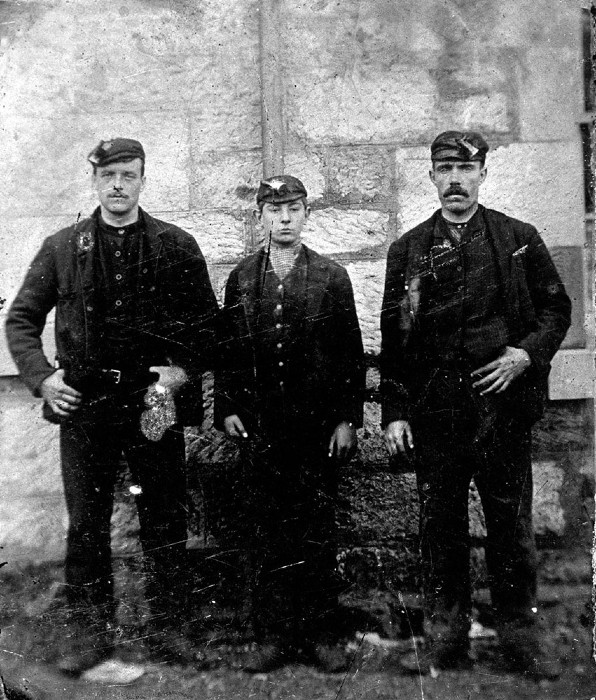Black and white photograph of three 19th Century miners