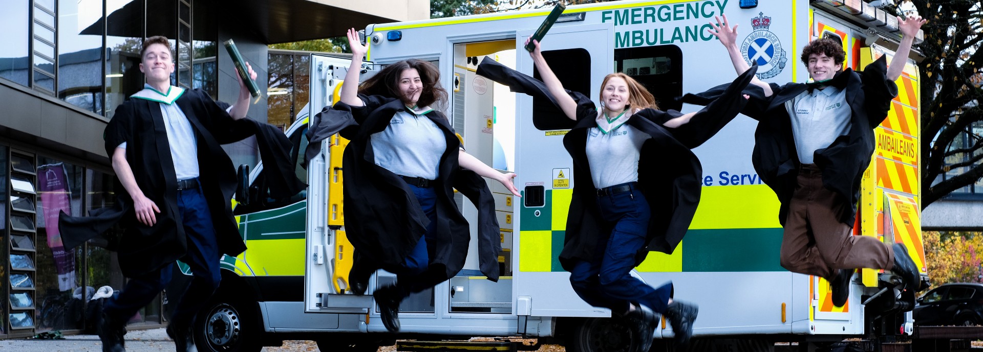 Paramedic graduates leap in front of ambulance