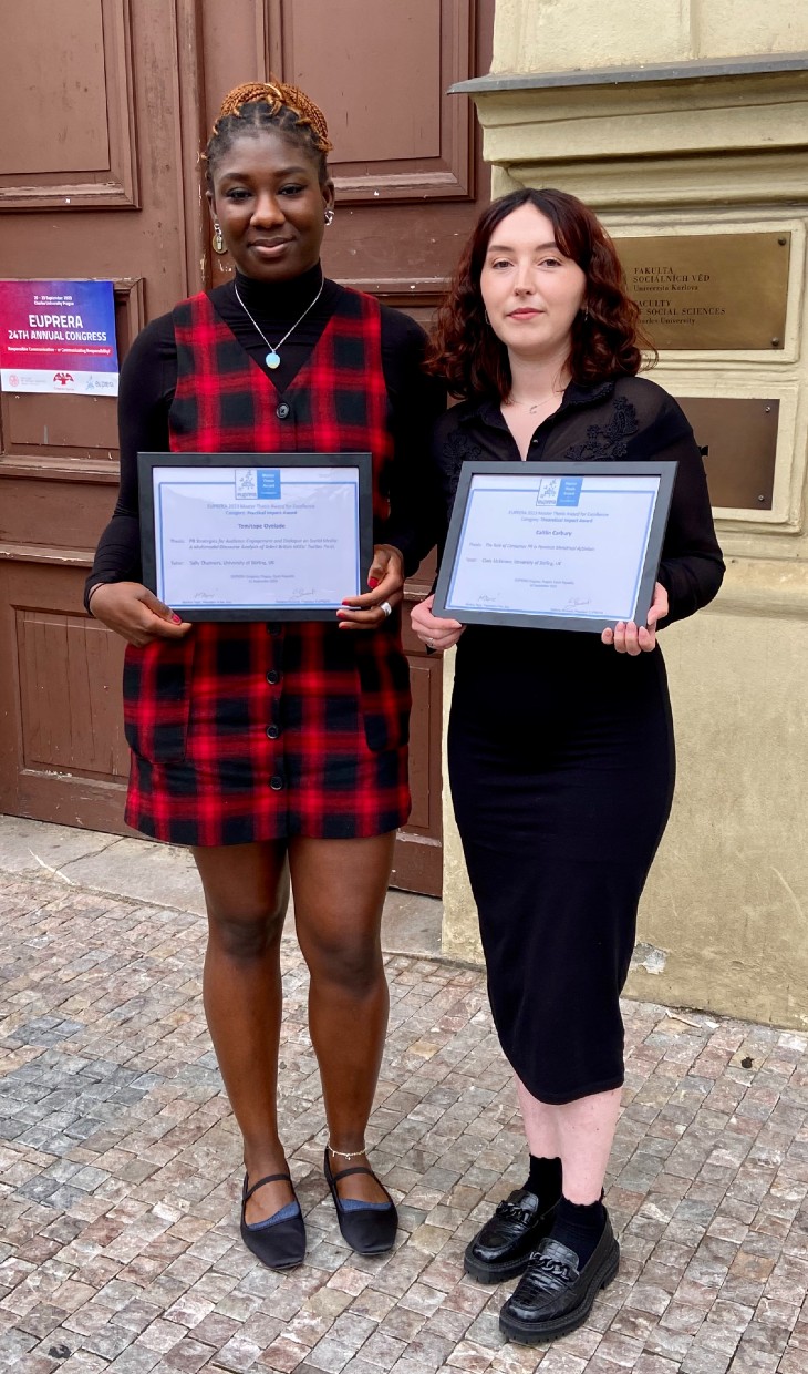 Graudates Temi and Caitlin pose with their awards