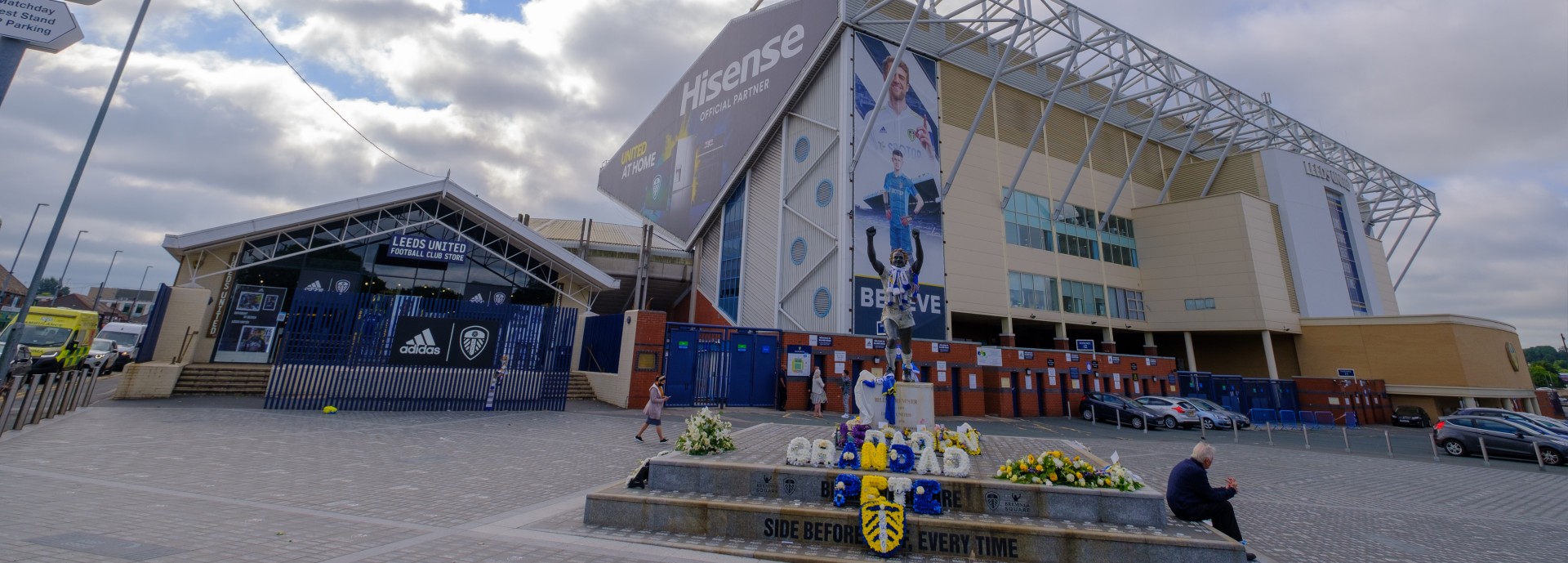 Exterior view of Elland Road football stadium with the Billy Bremner statue in the foreground in Leeds, England