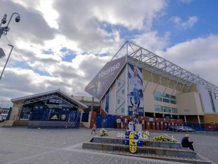 Exterior view of Elland Road football stadium with the Billy Bremner statue in the foreground in Leeds, England