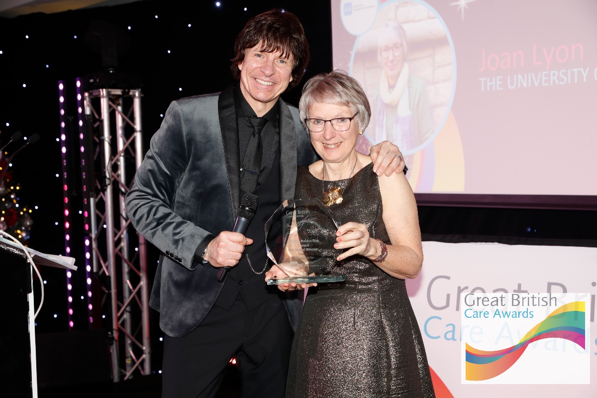 man and woman with award