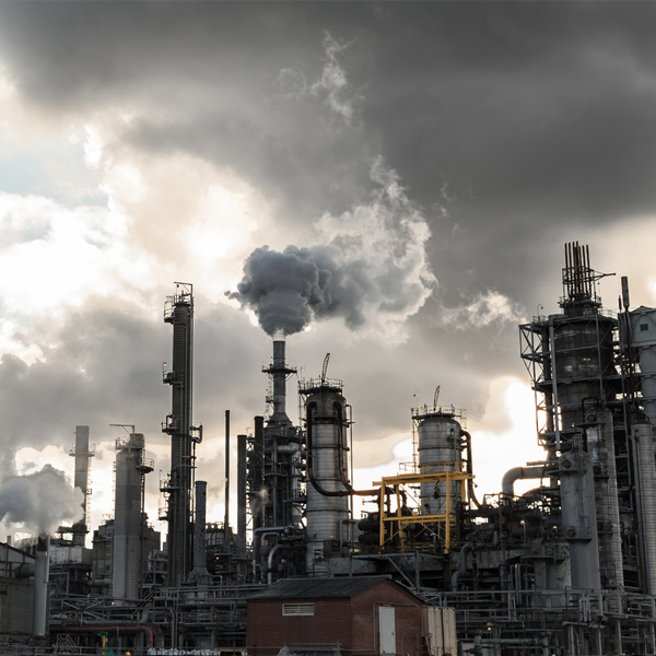 factory with smoke rising out of chimneys