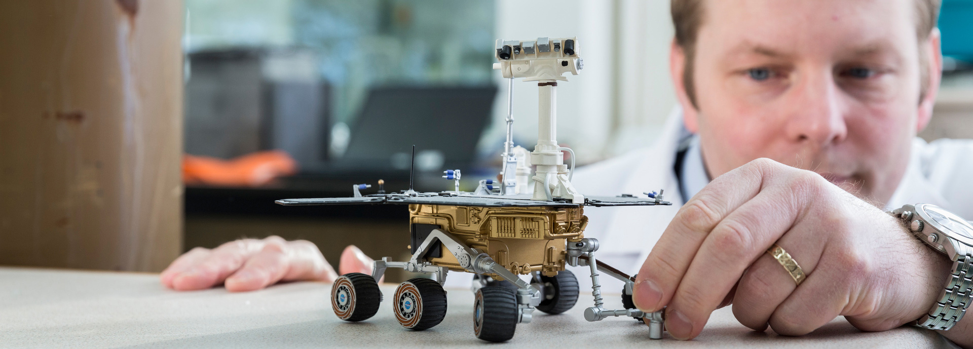 Man with model of Mars rover