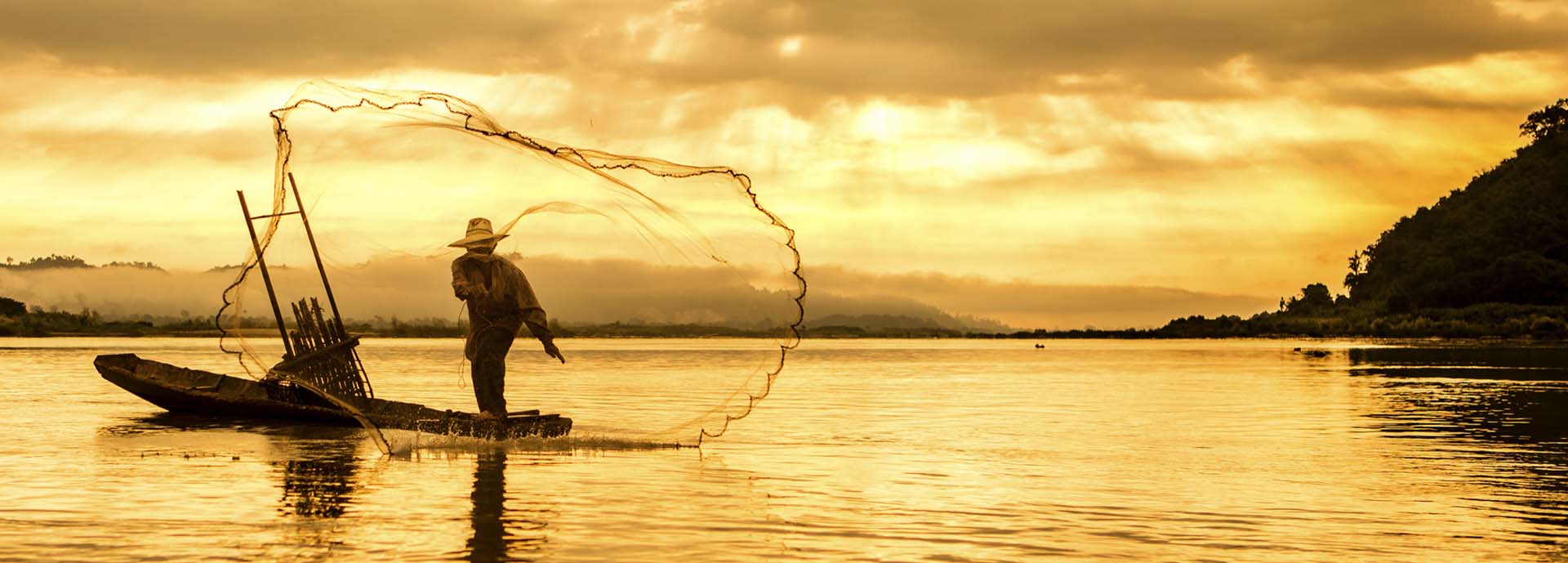 Fishing on lake at sunset