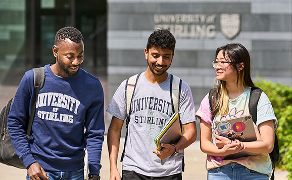 A group of students walking and looking happy